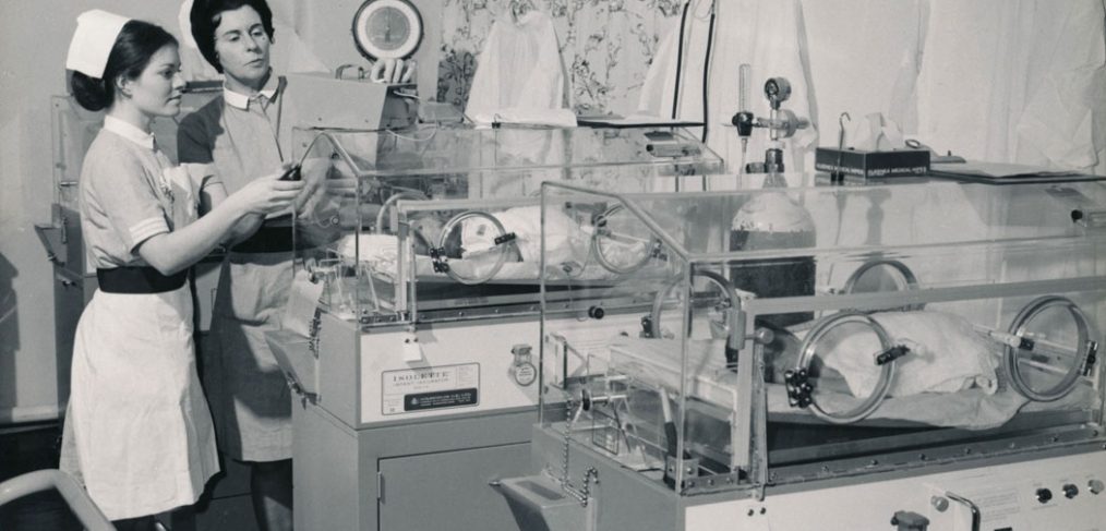 Staff midwife with student and babies in incubators