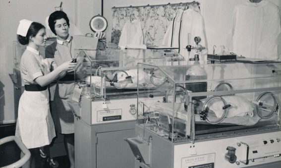 Staff midwife with student and babies in incubators