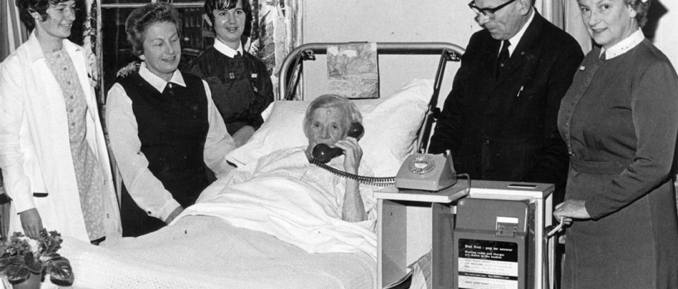 Chairman Ray Annetts with patient in bed using the new telephone