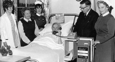 Chairman Ray Annetts with patient in bed using the new telephone