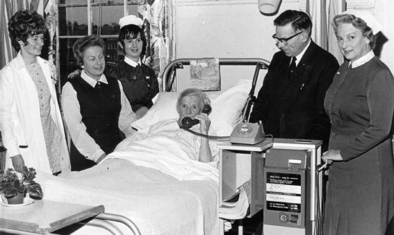 Chairman Ray Annetts with patient in bed using the new telephone