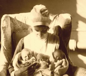 Nurse holds the triplets