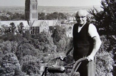 Gardener mowing lawn at Harnwood