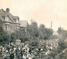 People dressed in ‘Sunday best’, women with long skirts and all with hats