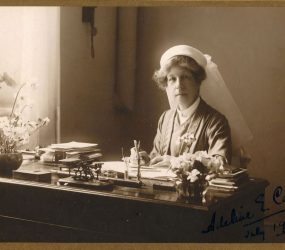 Adeline sat at writing desk