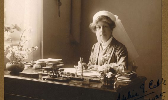 Adeline sat at writing desk