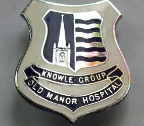 Blue and silver nurses badge with Salisbury Cathedral Spire