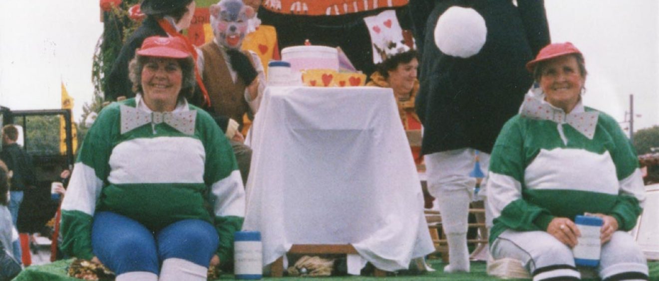 Decorated float with staff dressed as Alice in Wonderland characters