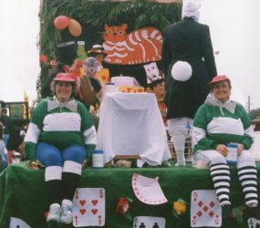 Decorated float with staff dressed as Alice in Wonderland characters
