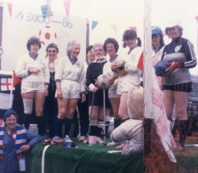 Staff on float dressed in football kit holding balls