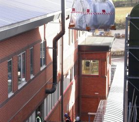 MRI scanner being lowered down the side of the hospital building