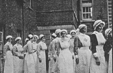 Black and white photograph of nurses in 1930 uniforms in a parade