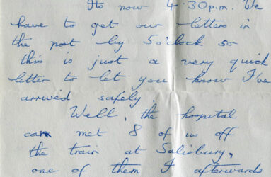 Handwritten letter on grey paper with blue biro writing