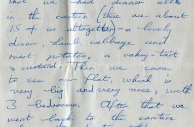 Handwritten letter on grey paper with blue biro writing
