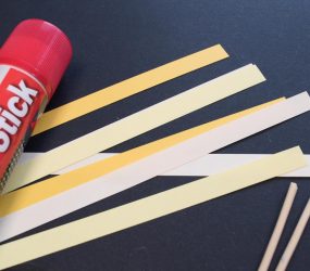 thin strips of paper in various shades of yellow