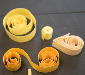 coiled strips of paper, some tightly, some looser, some with one edge squashed to a point