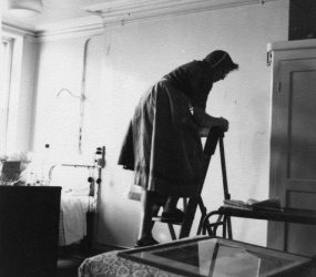 Orderly on step ladder on hospital ward