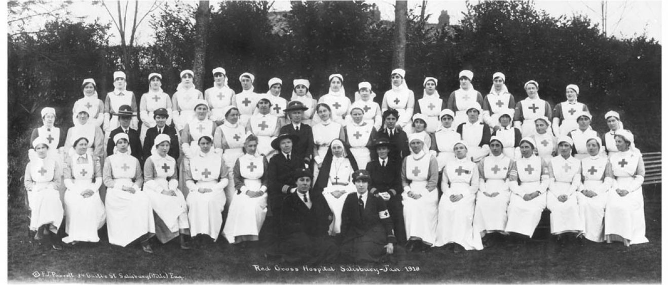Nurses and other hospital staff seated and standing in rows for photograph