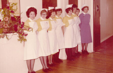Colour photograph showing nurses in uniform lined up