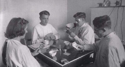 Black and white photograph showing a card game