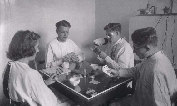 Black and white photograph showing a card game