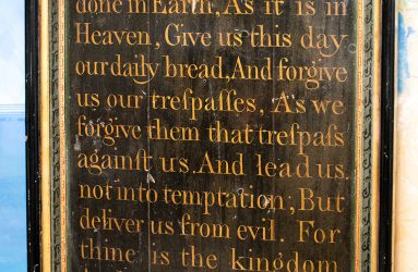 Oak panel arch shape with hand written lettering of Lord's prayer
