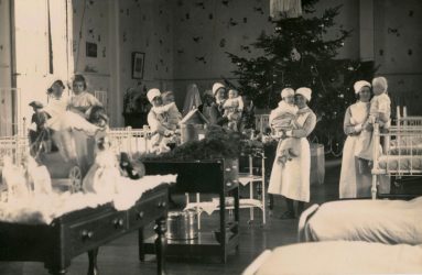 Nurses holding babies on ward