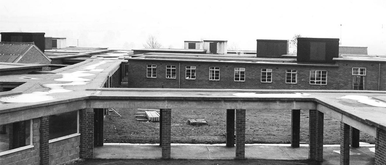 Walkway roof supported on brick pillars