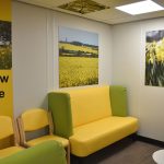 Eye clinic yellow zone, chairs with yellow vinyl and bright yellow flower artworks