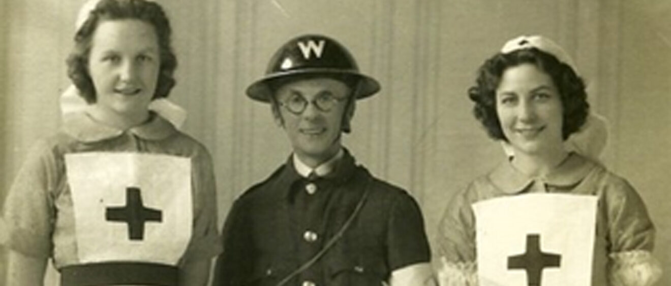 Sepia photo of 2 Red Cross Nurses and WW2 warden