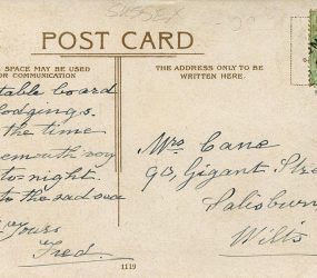 Message and address handwritten on back of postcard with half penny stamp and postmark