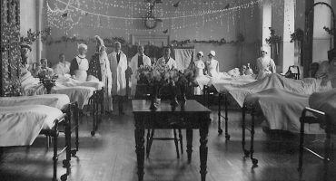 Doctors and nurses show off decorated ward for Christmas, 1930s