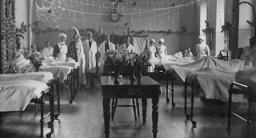 Doctors and nurses show off decorated ward for Christmas, 1930s