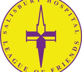 Yellow circle logo with purple spire