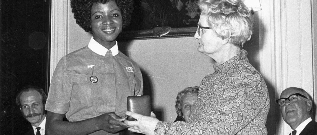 Nurse being presented with an award in a box