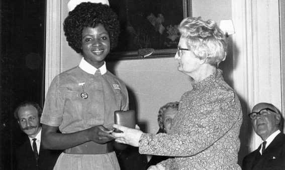 Nurse being presented with an award in a box