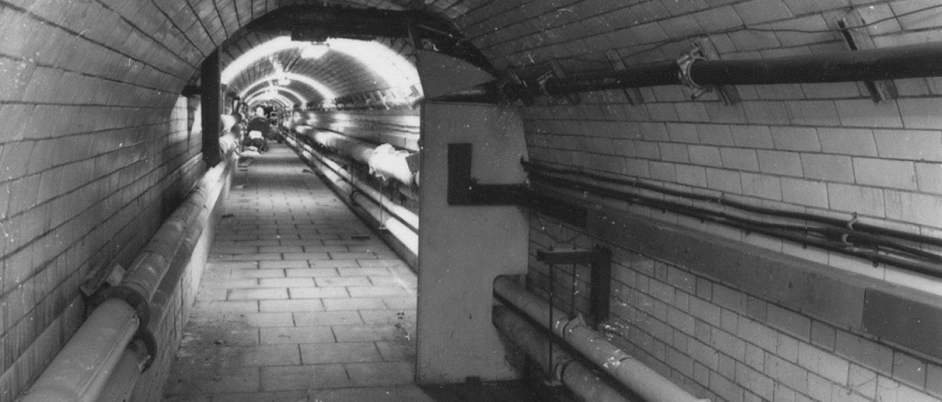 tiled tunnel with pipework visible