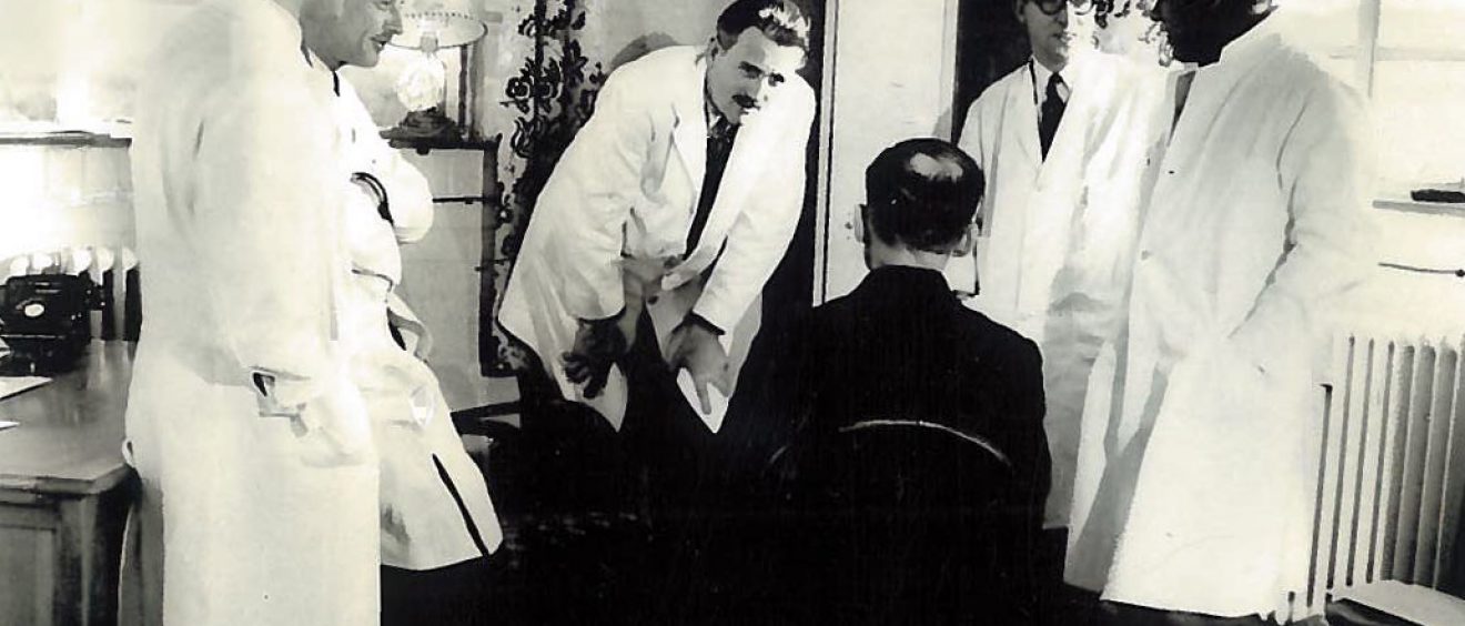 Dr Barron and colleagues consulting patient
