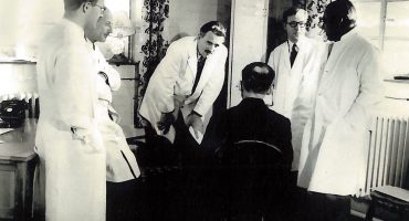 Dr Barron and colleagues consulting patient