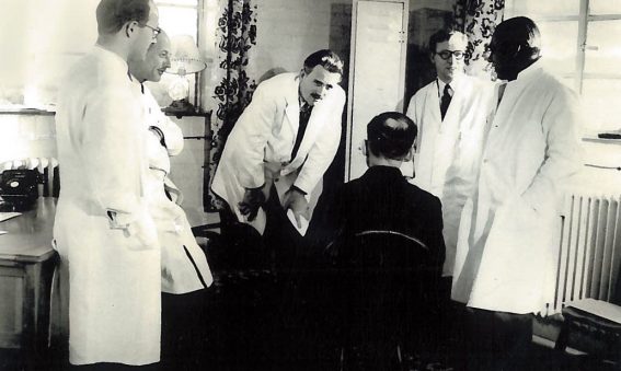 Dr Barron and colleagues consulting patient