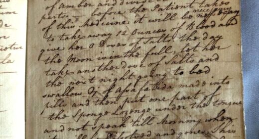 colour photograph of historic prescription book, with ink handwriting