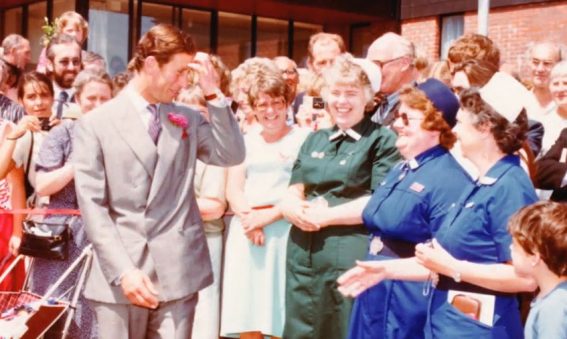 Prince Charles standing with crowds of staff and patients outside Spinal Unit entrance