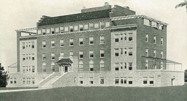 Hospital building on 5 levels, steps leading to covered porch entrance