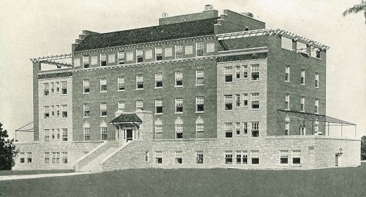 Hospital building on 5 levels, steps leading to covered porch entrance