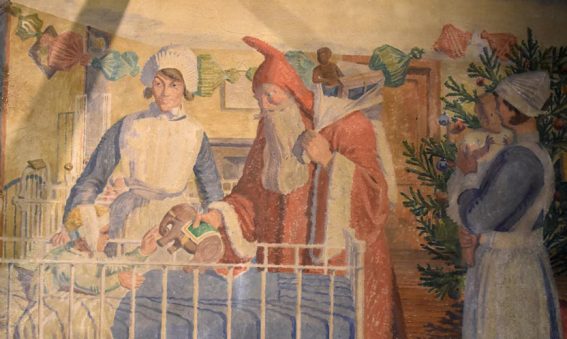 Painting showing nurse with Father Christmas giving present to child in cot